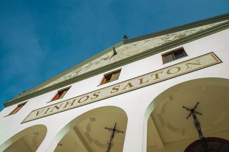 Bento Goncalves, Brazil - July 10, 2019. Painted pediment and company signboard on the facade of Salton Winery building near Bento Goncalves. A friendly country town famous for its wine production.のeditorial素材