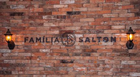 Bento Goncalves, Brazil - July 10, 2019. Sign on brick wall with the brand Salton Family in the Salton Winery, near Bento Goncalves. A friendly country town famous for its wine production.のeditorial素材