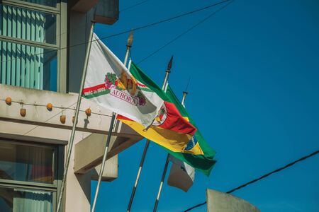 Bento Goncalves, Brazil - July 11, 2019. Flags from the Aurora Winery company, Rio Grande do Sul state, Brazil and city of Bento Goncalves. A friendly country town famous for its wine production.のeditorial素材