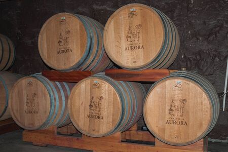 Bento Goncalves, Brazil - July 11, 2019. Pile of wood barrels for storage and wine aging in a cellar from the Aurora Winery at Bento Goncalves. A friendly country town famous for its wine productionのeditorial素材