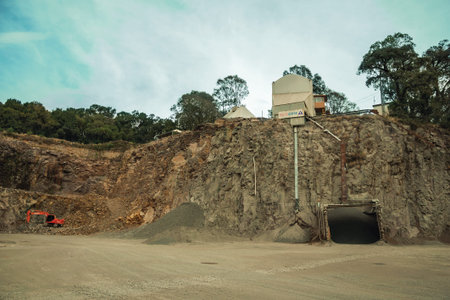 Bento Goncalves, Brazil - July 13, 2019. View of rocky escarpment and equipment in a quarry facility...