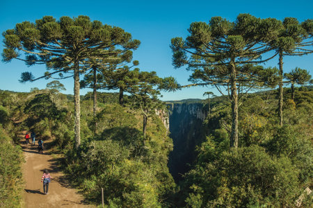 Cambara do Sul, Brazil - July 16, 2019. Dirt pathway and people at the Itaimbezinho Canyon with rocky cliffs near Cambara do Sul. A small country town with amazing natural tourist attractions.のeditorial素材
