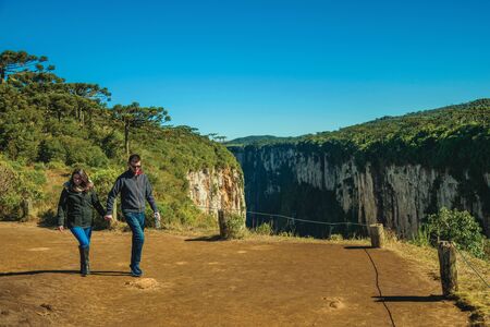 Cambara do Sul, Brazil - July 16, 2019. Dirt pathway and people at the Itaimbezinho Canyon with rocky cliffs near Cambara do Sul. A small country town with amazing natural tourist attractions.のeditorial素材