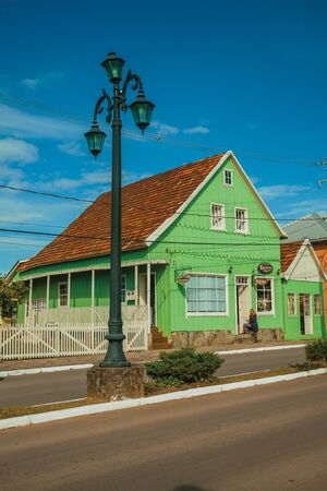Cambara do Sul, Brazil - July 19, 2019. Wooden old houses and store in the calm Getulio Vargas Avenue, the main street of Cambara do Sul. A small rural town with amazing natural tourist attractions.のeditorial素材