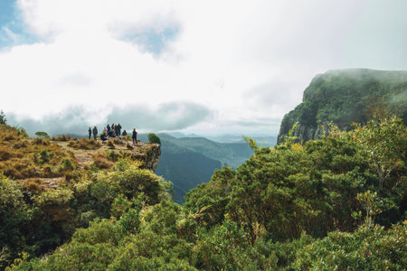 Cambara do Sul, Brazil - July 18, 2019. People on the edge of steep rocky cliff at Fortaleza Canyon in a cloudy day near Cambara do Sul. A small rural town with amazing natural tourist attractions.のeditorial素材
