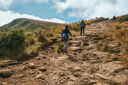Cambara do Sul - Brazil, July 18, 2019. People on rocky trail going up to the top of Fortaleza Canyon in a sunny day near Cambara do Sul. A small rural town with amazing natural tourist attractions.のeditorial素材