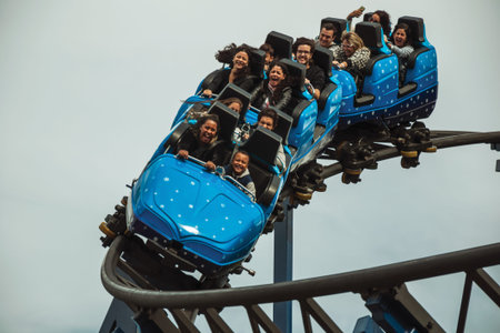 Canela, Brazil - July 21, 2019. People in a blue cart having fun on roller coaster in a cloudy day at the Alpen amusement park near Canela. A charming small town very popular by its ecotourism.のeditorial素材