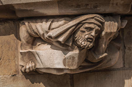 Decorative sculpture in human format on a gothic building in Ghent. A city full of canals and old buildings in Flemish style. Northern Belgium.の写真素材