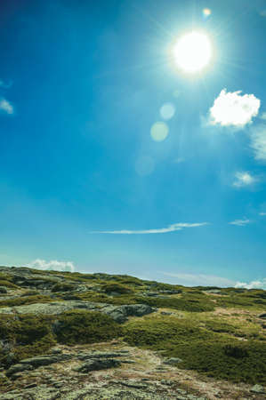 Hilly landscape in a sunny day covered by bushes and rocks on highlands of the Serra da Estrela. The highest mountain range in continental Portugal.の写真素材