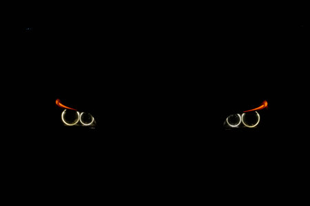 yellow car headlights on black field