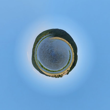 Little planet 360 degree panorama view of a small town on the sea coast.