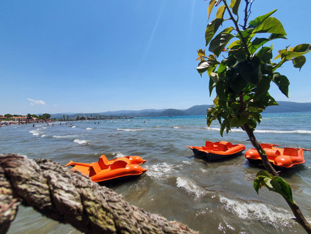 Deep blue sea and orange pedal boats at AlaÃ§atÄ± beach.の写真素材
