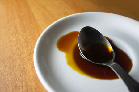 Honey collected in a spoon. Pure honey.の写真素材