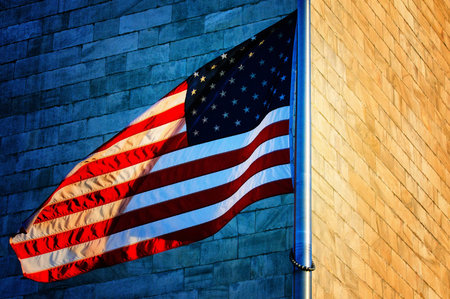 Low angle view of Washington Monument and American Flag, Washington DC, USAの写真素材
