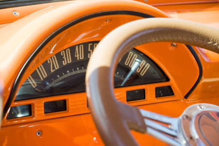 A vintage car dashboard and steering wheel.の写真素材