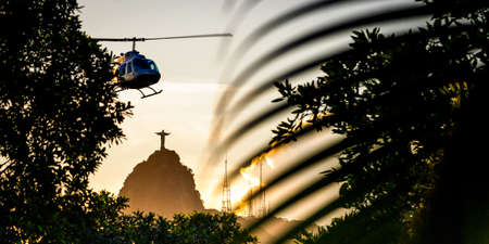 Helicopter flying in the sky with Christ The Redeemer statue in the background, Corcovado, Rio de Janeiro, Brazilの写真素材