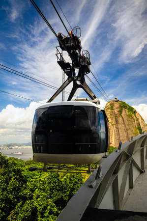 Overhead cable car approaching Sugarloaf Mountain, Guanabara Bay, Rio De Janeiro, Brazilの写真素材