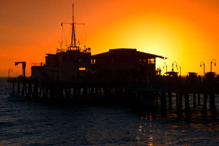 Silhouette of a pier in the ocean, Santa Monica Pier, Santa Monica, Los Angeles County, California, USAの写真素材