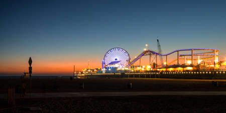 Ferris wheel on Santa Monica Pier lit up at dusk, Santa Monica, Los Angeles County, California, USAの写真素材