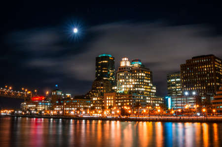 Buildings at the waterfront lit up at night in San Francisco, California, USAの写真素材