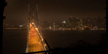 Elevated view of the Bay Bridge lit up at night, San Francisco, North Beach, California, USAの写真素材
