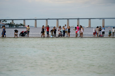 Rio de Janeiro, Brazil - may 01, 2017:  Cariocas and tourists enjoy the holiday, strolling along the waterfront. In the background, the Rio-Niteri bridgeのeditorial素材