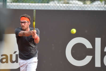 Rio de Janeiro, Brazil - february 20, 2017: Pablo Adujar (ESP) x Geral MELZER (AUT)  classificatory game during Rio Open 2018 held at the Jockey Club Brasileiro.のeditorial素材