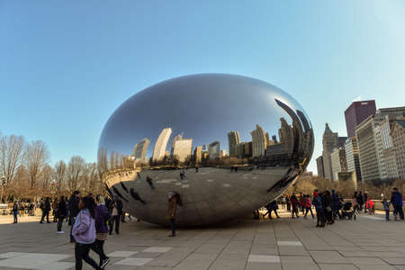 Chicago, Il, USA - march 22, 2018:  reflecting the buildings on the Cloud Gate statue in Millenium Park, central city, with some tourist walking aroundのeditorial素材