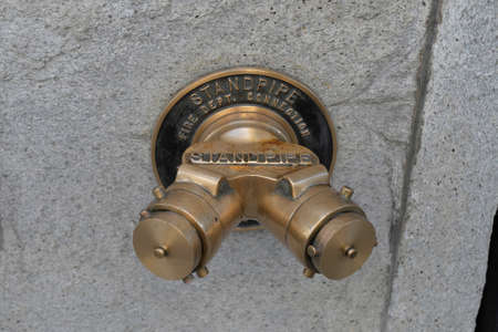 hydrant point on a wall in the streetの写真素材