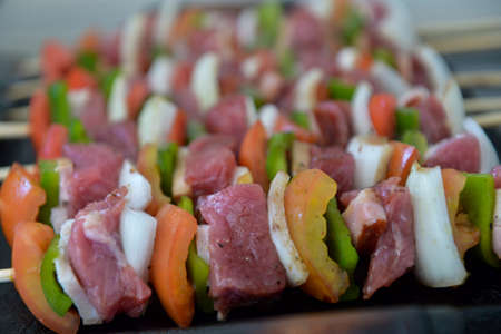 mixed barbecue skewer of raw meat and vegetablesの写真素材