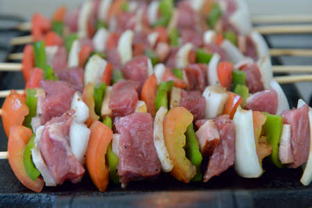 mixed barbecue skewer of raw meat and vegetablesの写真素材