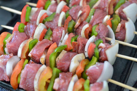 mixed barbecue skewer of raw meat and vegetablesの写真素材