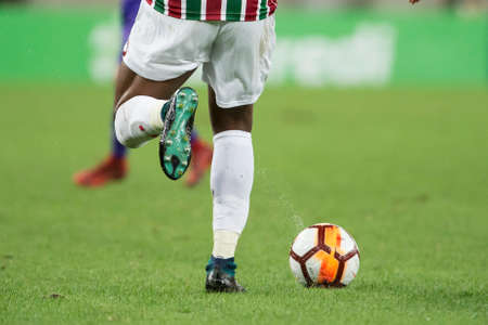 Rio, Brazil - august 02, 2018: Legs and ball of player running in match between Fluminense and Defensor by the sudamerica cup in Maracana Stadiumのeditorial素材