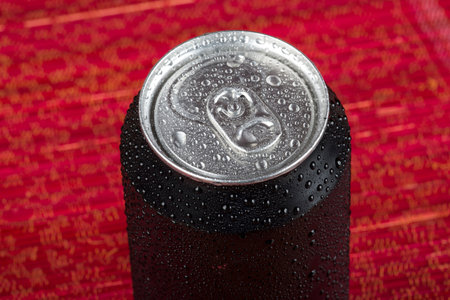 black aluminum can, with drops of water.