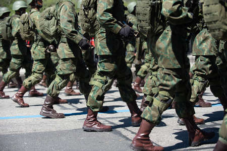 Military marching in a street. Legs and shoes in line.のeditorial素材