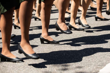 Women military marching in a street. Legs and shoes in line.のeditorial素材