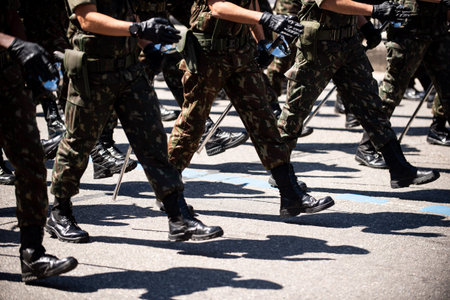 Military marching in a street. Legs and shoes in line.