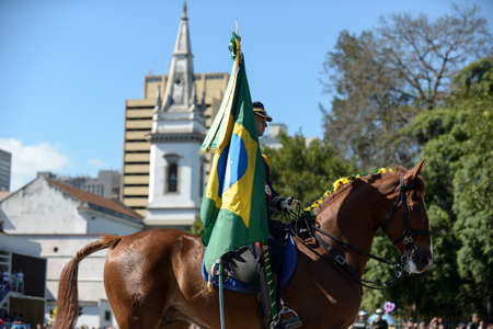 Rio de Janeiro, Brazil - september 07, 2018:  military civic parade celebrating the independence of Brazil. Military over a horse holding a brazilian flagのeditorial素材