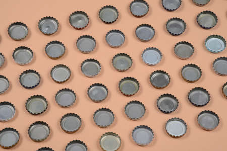 bottle caps lined up in color background.の写真素材