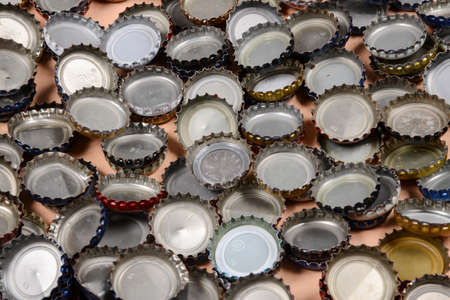 Pile of bottle caps on a nude background.の写真素材