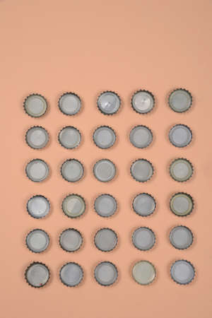 bottle caps lined up in color background.の写真素材