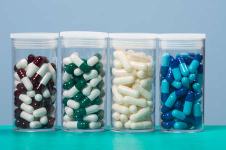 colored capsule of medicine in plastic storage container.の写真素材