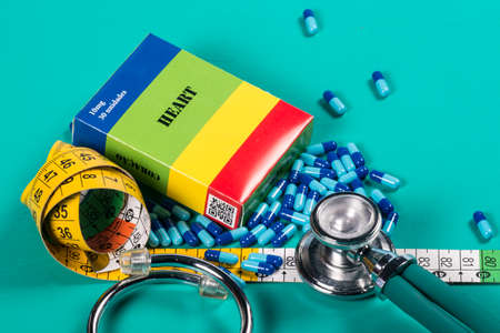 medicine box with some blue capsule and measuring tapeの写真素材