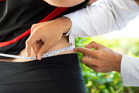 Rio de Janeiro, Brazil - november 22, 2018: health professional measuring a patient's waistのeditorial素材