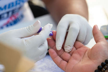 Rio de Janeiro, Brazil - november 22, 2018: Healthcare Professional Gets Fast Blood Glucose Testing during screening campaignのeditorial素材