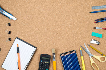 School elements on cork background with space for text symbolizing back to school.の写真素材