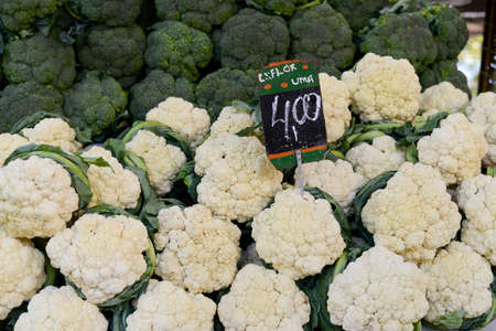 vegetable market in open-air market with broccoli and cauliflower and price of the productsの写真素材
