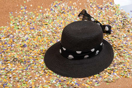 Background of confetti with elements related to the carnival and summer. Women black hatの写真素材