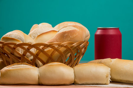 basket of french breads on a table and a cola can