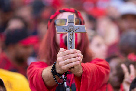 Rio, Brazil - april 21, 2019: fans holds a cross and prays in match between Flamengo and Vasco by the final Carioca Championship in Maracana Stadiumのeditorial素材